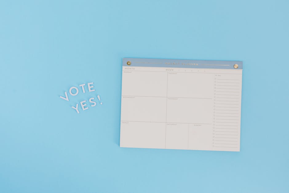 Minimalist image of a planner and "Vote Yes" text on a blue background, perfect for election themes.