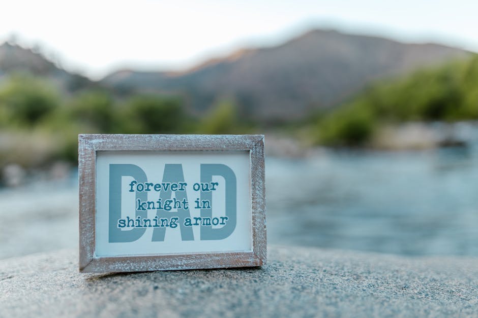 Close-up of a framed Father's Day message by a serene riverside, perfect for celebrations.