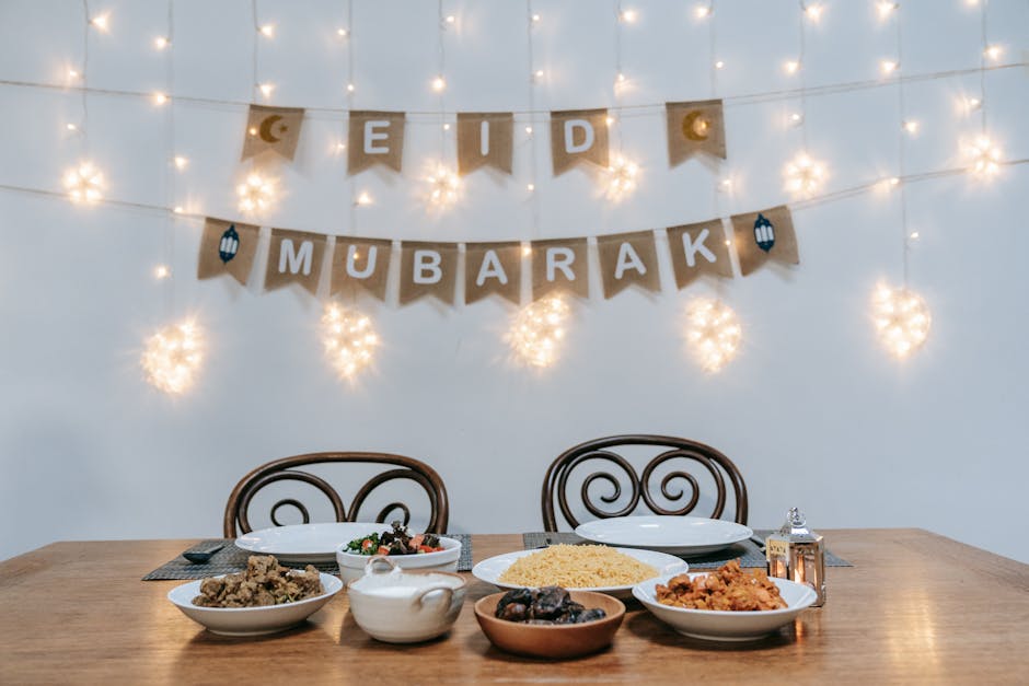 A beautifully set table for Eid Mubarak with decorative lights.