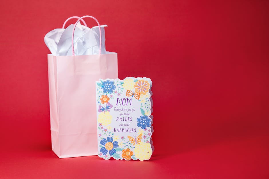 A colorful Mother's Day card with a gift bag against a red backdrop. Perfect for celebrations.