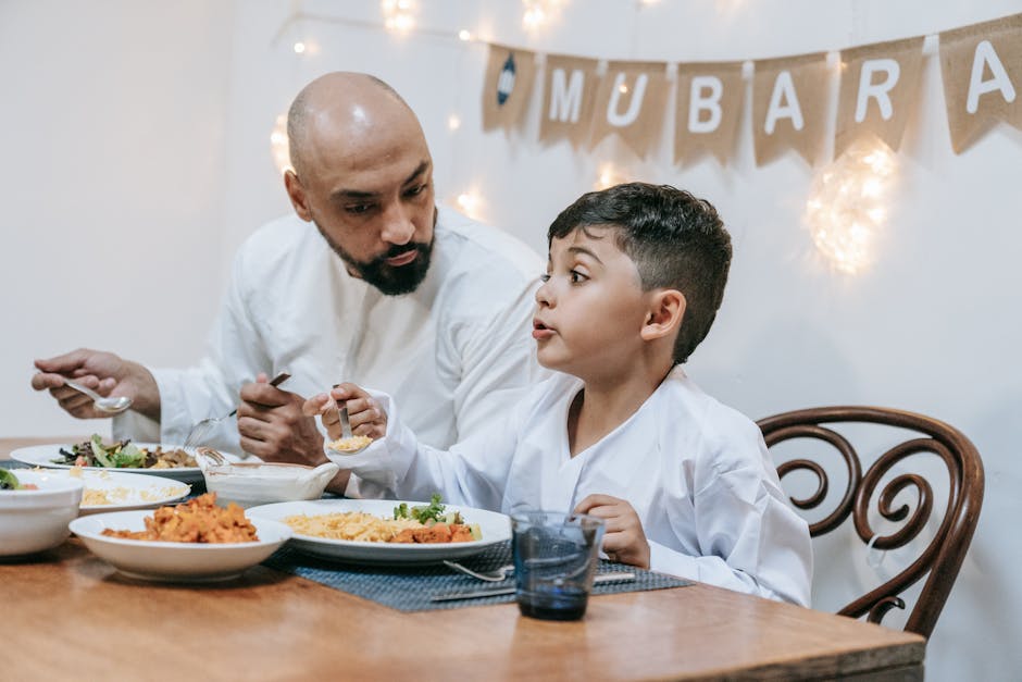 Father and son enjoy a festive meal during Eid Mubarak celebration.