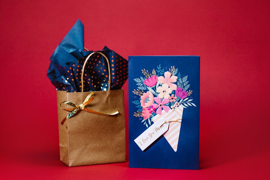 A Mother's Day card with a gift bag against a vibrant red background.