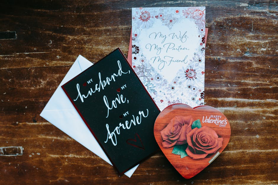 Heartfelt Valentine's Day cards and a heart-shaped chocolate box on a wooden surface, perfect for a romantic gift.