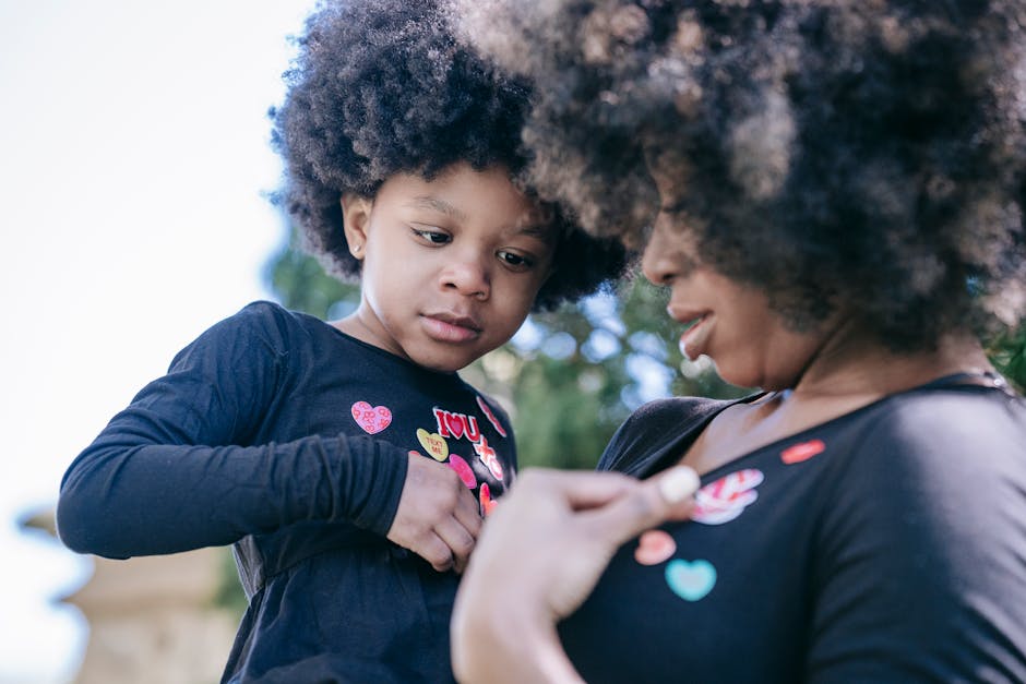 A tender moment between a mother and daughter sharing love and connection outdoors.