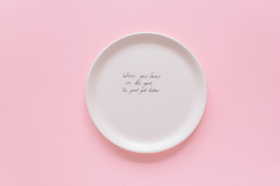 Minimalist plate with motivational quote on pink background.
