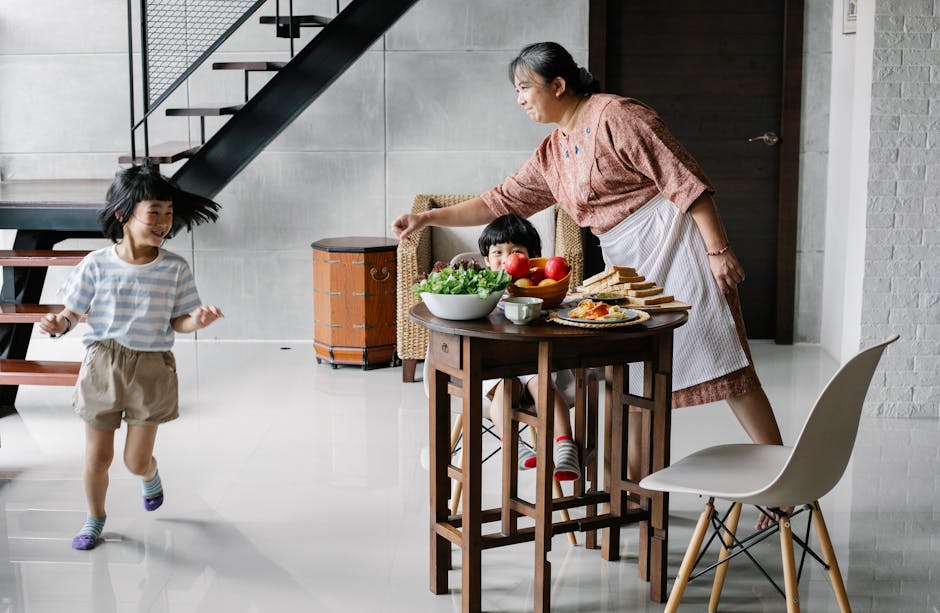 Joyful morning scene with grandma and kids having breakfast at home.