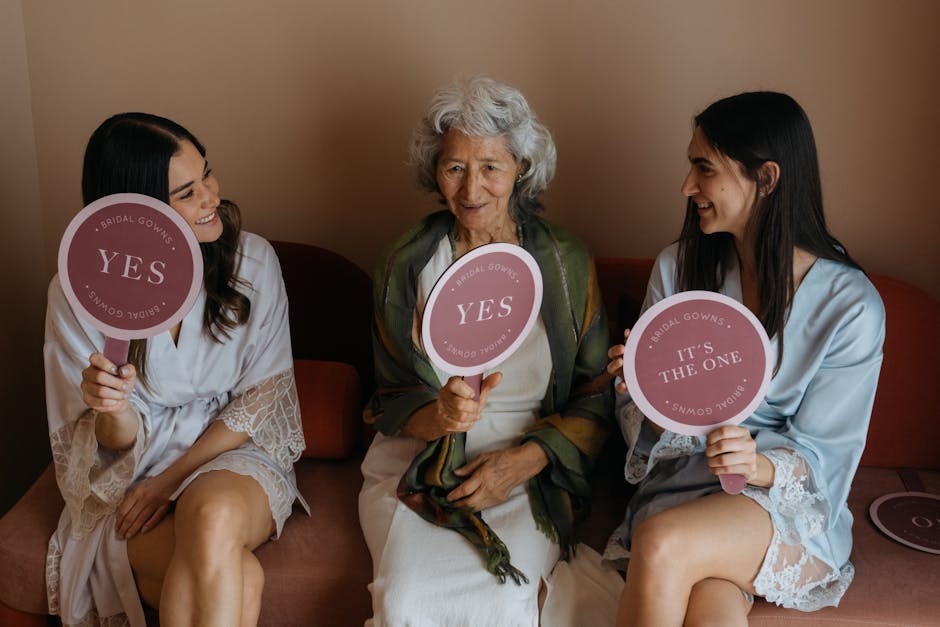 Grandmother and bridesmaids share joy holding signs during wedding preparations.