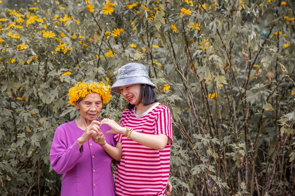 Elderly woman and young woman bonding in a garden full of blooming flowers in Vietnam.