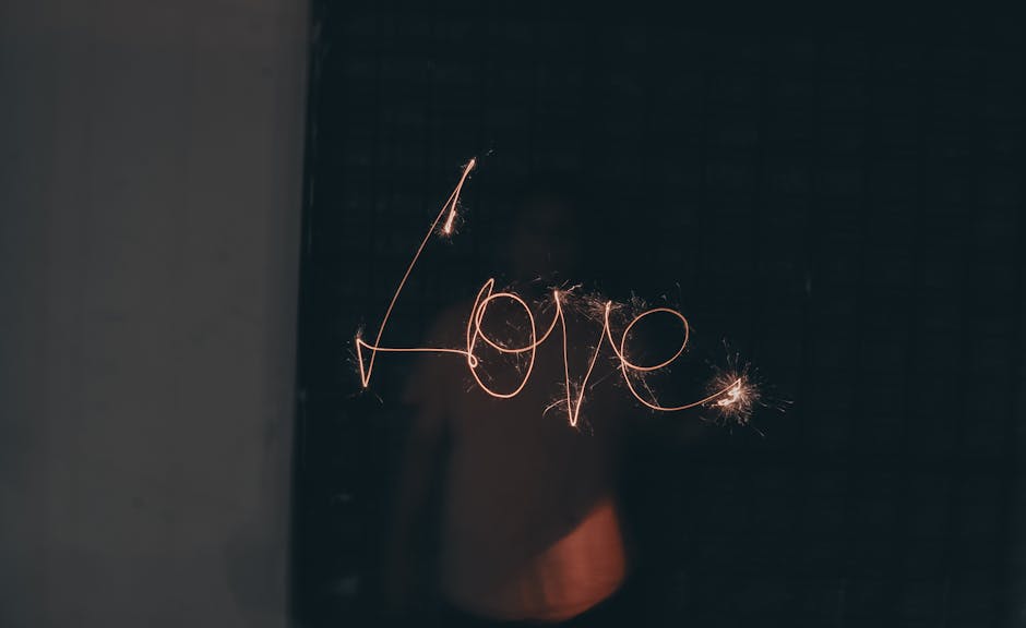 A captivating image of the word 'Love' written with sparklers in low light.