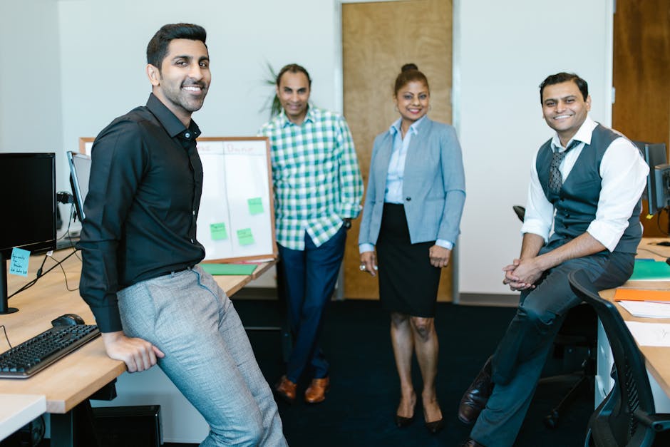 A diverse team of colleagues discussing business strategies in a modern office environment.