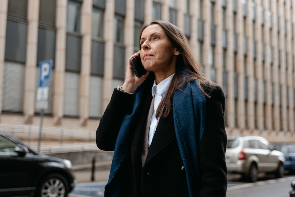 Confident businesswoman talking on the phone in the city street.