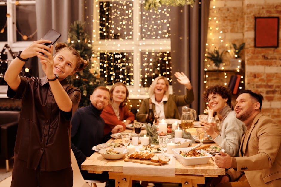 A joyful family capturing a selfie during a festive Christmas dinner indoors.
