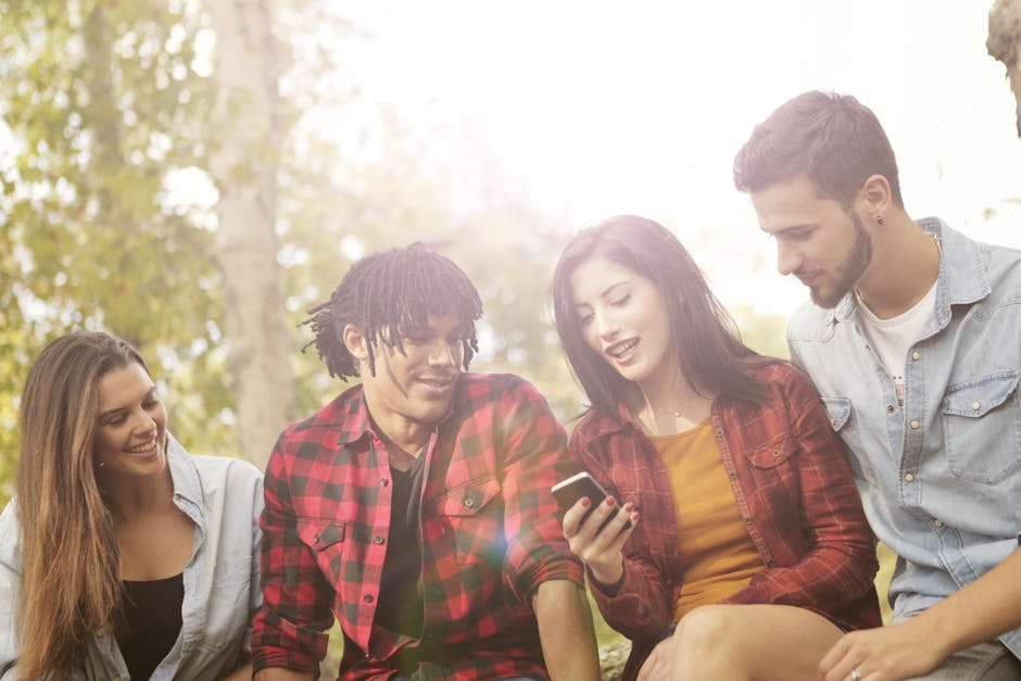 Group of young adults laughing and enjoying a sunny day together outdoors.
