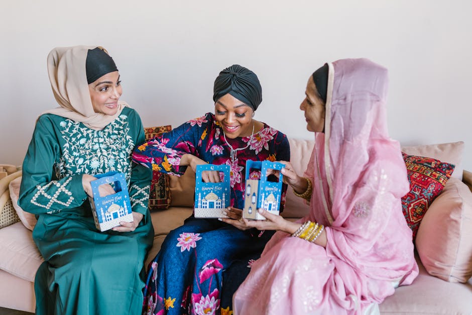 Three women share gifts and happiness during an Eid celebration, showcasing cultural diversity.