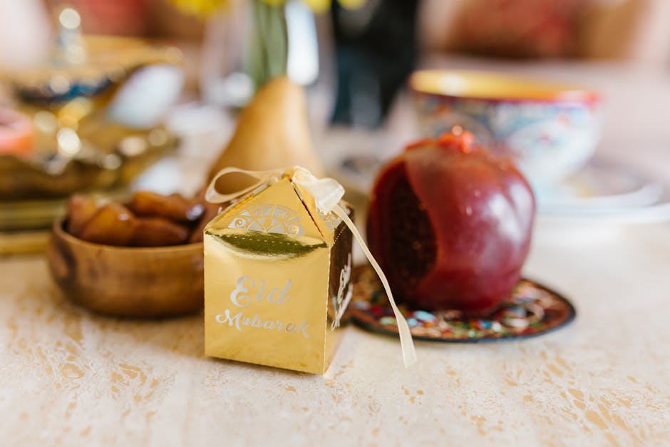 Warm and inviting Eid table setting with a decorative gift box, pomegranate, and traditional dishes.