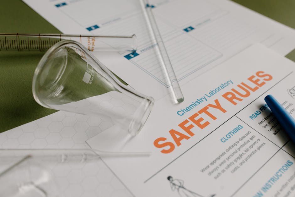 An image of laboratory safety rules and glassware in a chemistry lab.