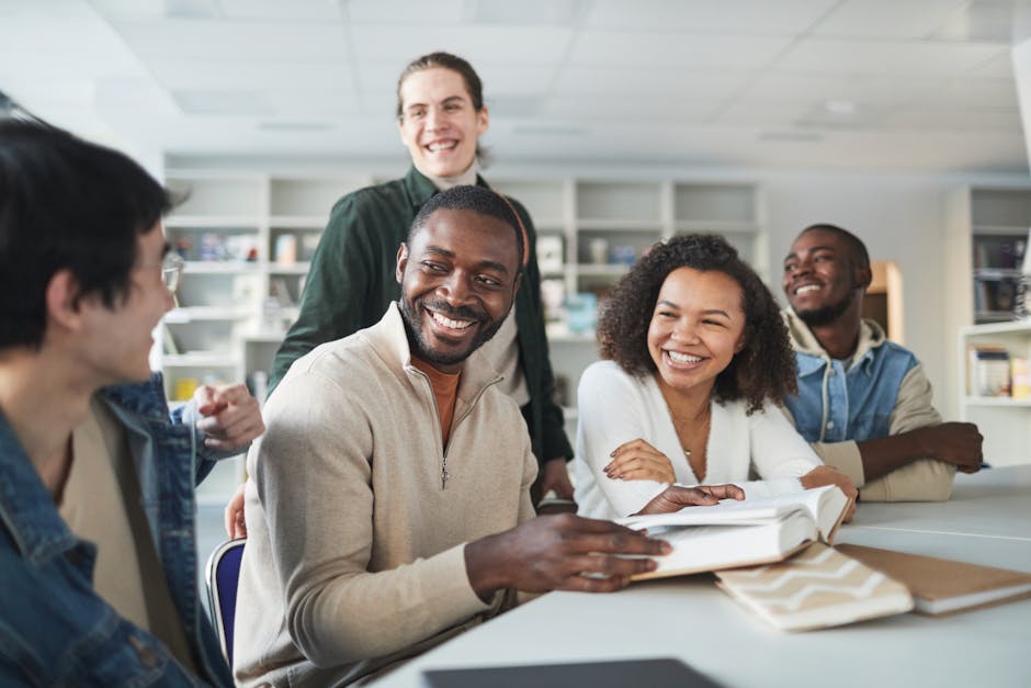 A group of diverse students happily studying and collaborating in a library setting.