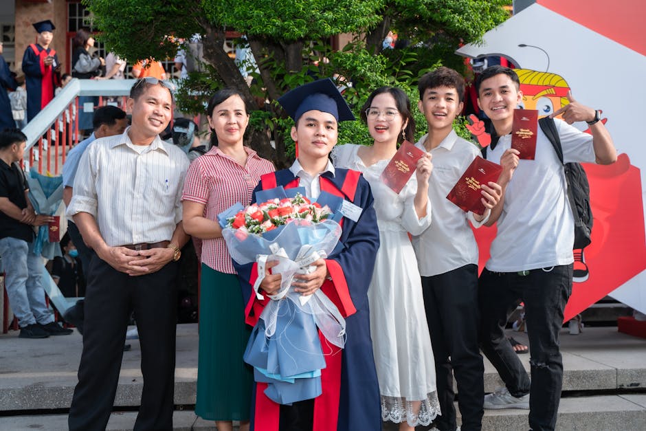Happy graduates celebrate achievement with family and friends outdoors.