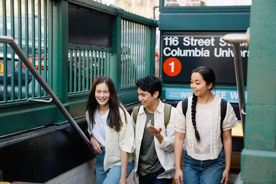 Three young adults walking out of a subway station near Columbia University in New York City.