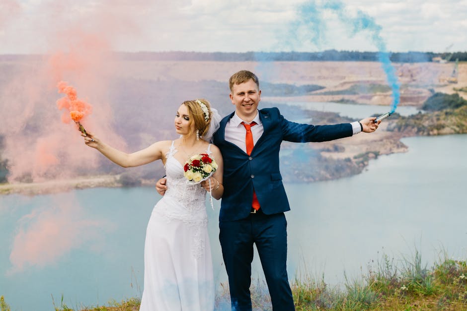 Bride and groom celebrating with colorful smoke on a scenic outdoor wedding day.
