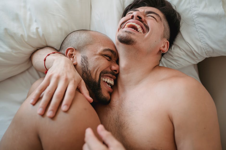 Loving and joyful moment between an affectionate couple relaxing and laughing together indoors.