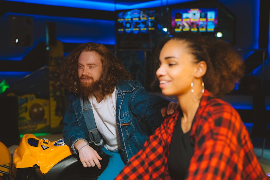 A happy couple having fun indoors at an amusement center, enjoying arcade games.