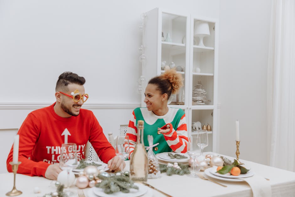 Couple enjoying holiday meal in festive sweaters, embracing Christmas spirit indoors.