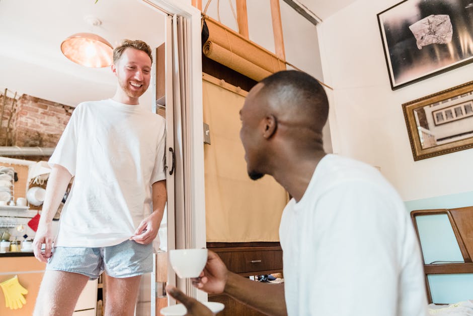 A happy couple enjoying a casual morning with coffee in their cozy living room.
