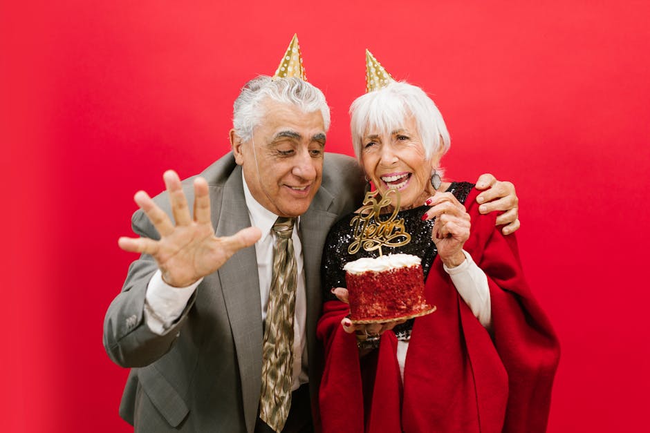 Joyful elderly couple celebrating 60th anniversary with cake and laughter.