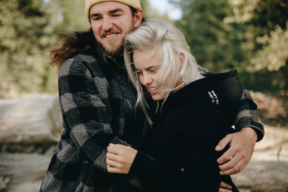 Smiling couple hugging in a serene outdoor environment. Perfect for lifestyle and relationship themes.