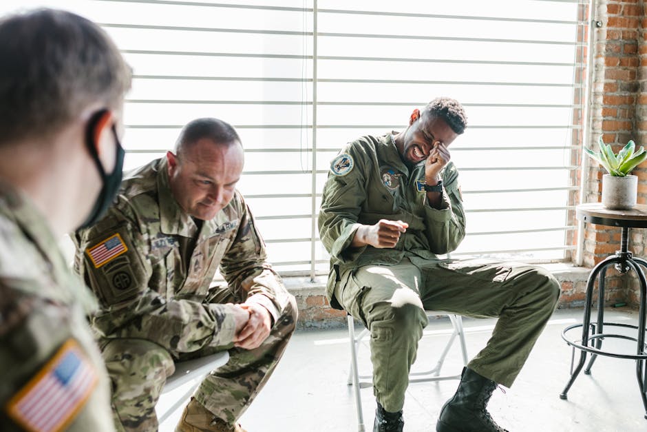 Veterans share a light moment during a group therapy session, indoors.