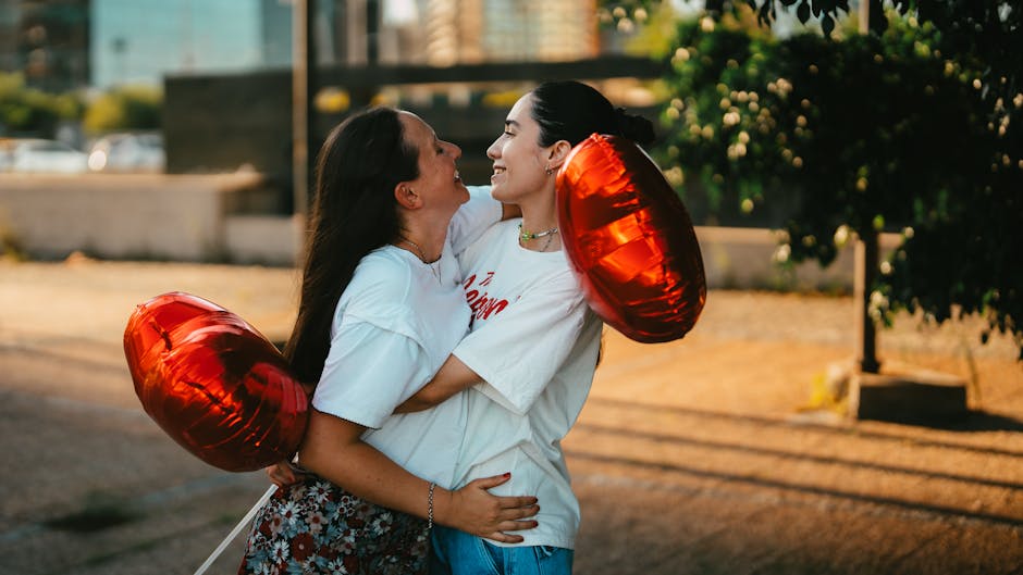 A happy couple embraces outdoors in Buenos Aires, holding heart-shaped balloons. Perfect for themes of love and celebration.