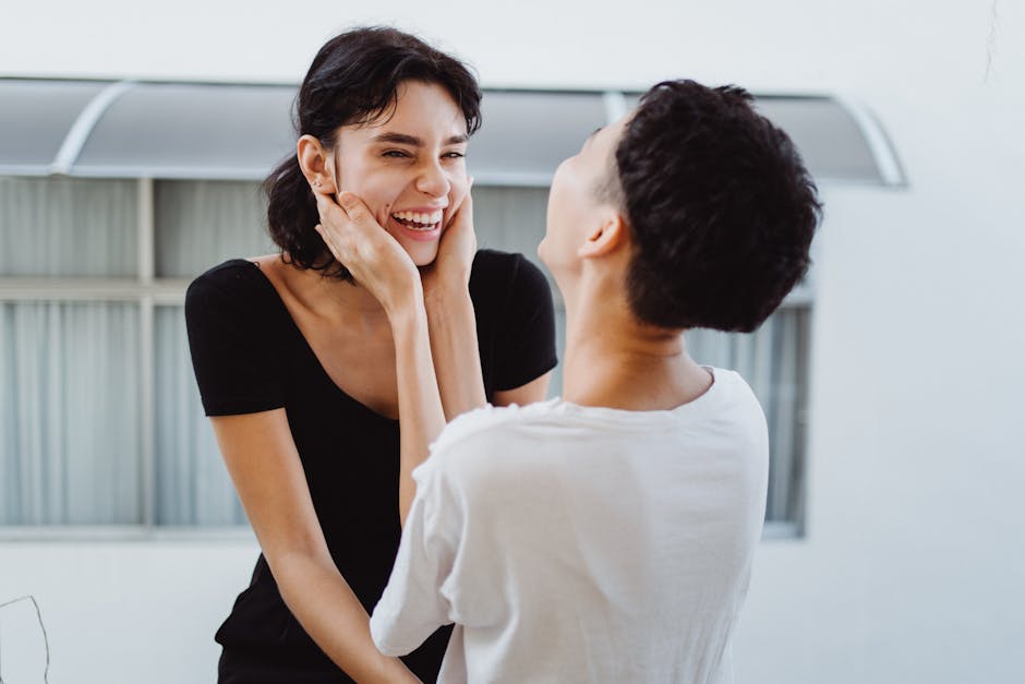 Two women joyfully interacting outdoors, reflecting happiness and love.