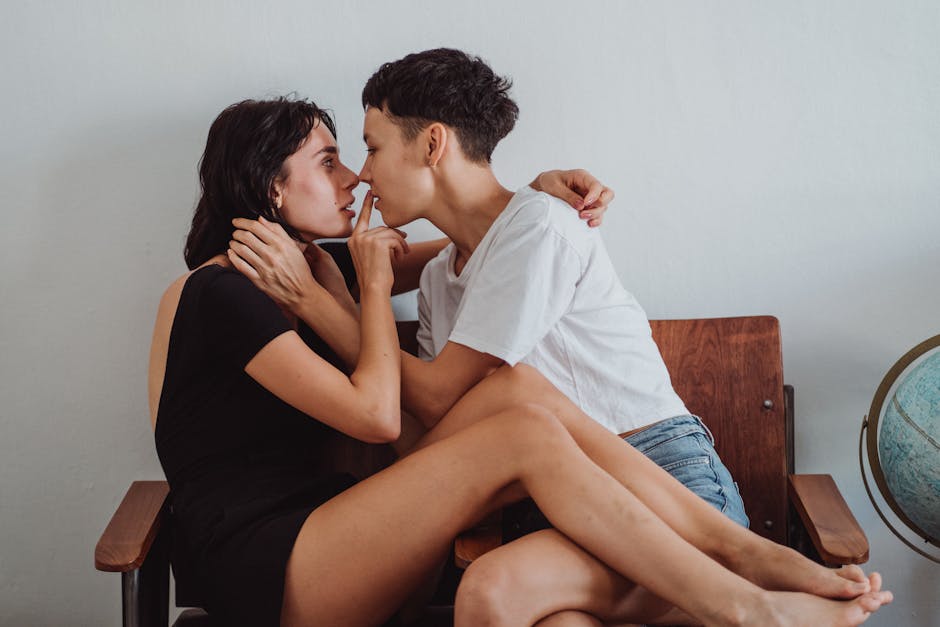 A tender embrace between two women sharing a delicate and loving moment.