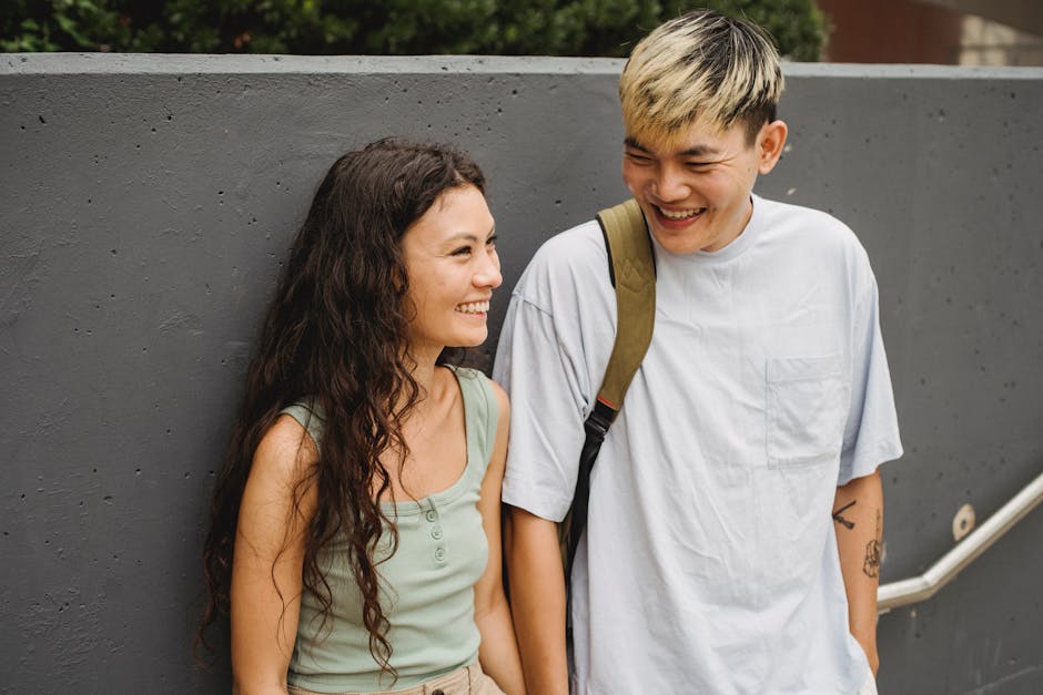 Young diverse couple smiling and bonding outdoors on a casual summer day.