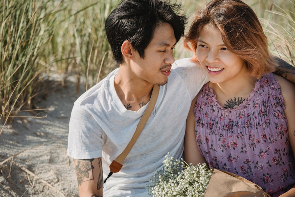 A happy couple sitting together outdoors, sharing a joyful moment with nature.