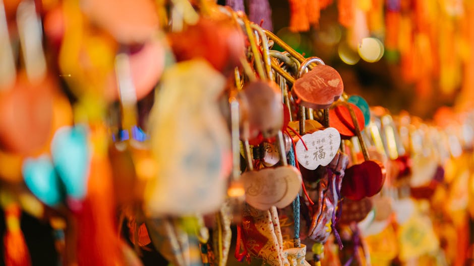 Close-up of vibrant love locks and heart-shaped charms hanging in a row.