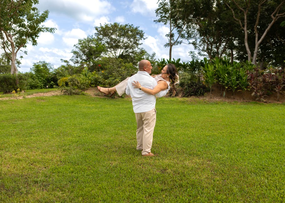 A couple in love embracing in a lush green park in Mérida, perfect for conveying romance and happiness.