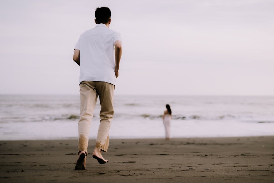 A couple enjoying a serene moment on a beach in Indonesia, capturing love and connection.