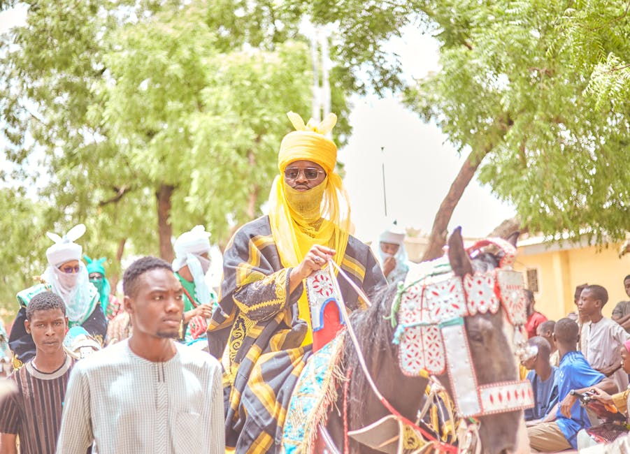 Vibrant African parade featuring traditional attire and horsemen. Captures cultural essence.