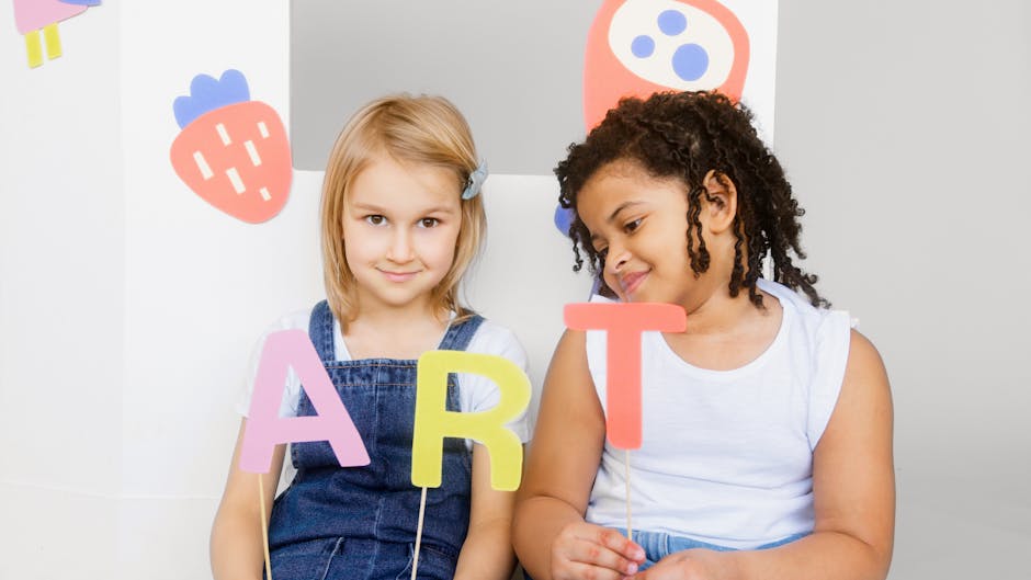 Two children holding colorful 'ART' letters in a creative classroom setting.