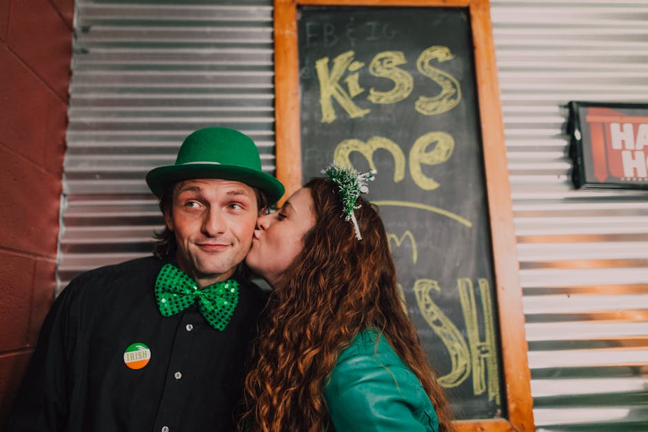 Cheerful couple celebrating St. Patrick's Day with costumes and decor.