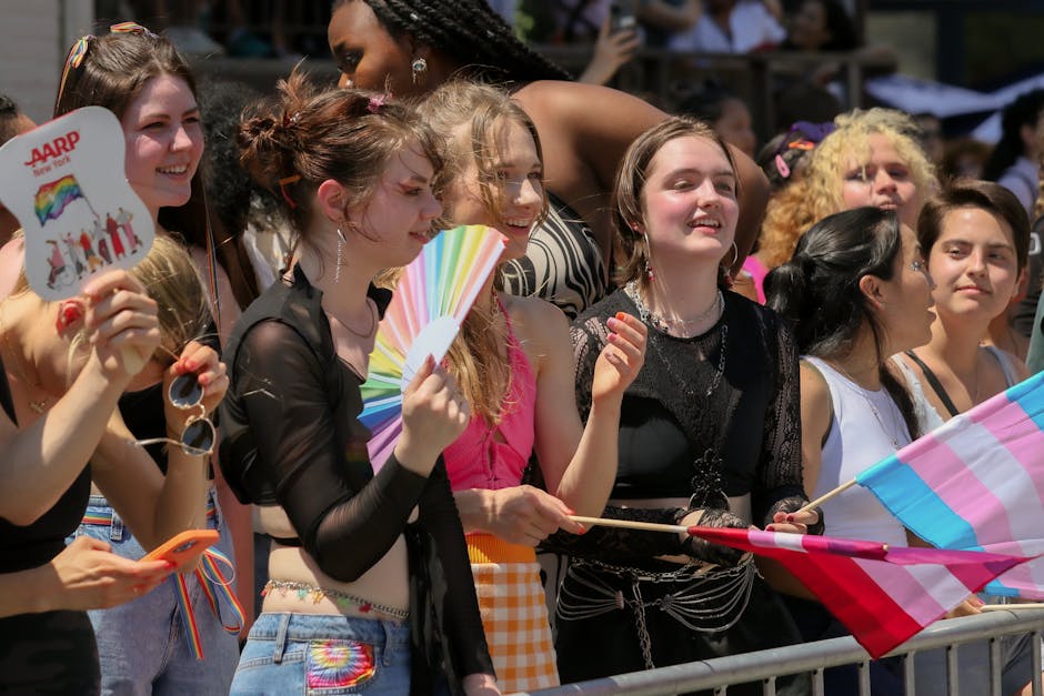 Vibrant group of diverse individuals celebrating at a pride parade in New York City during the day.