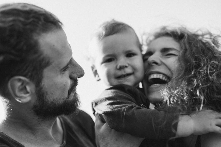 A happy family enjoying a heartfelt moment together in a black-and-white setting.