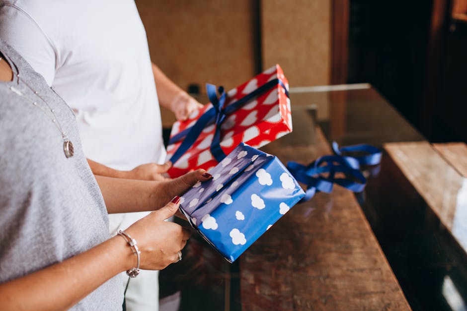 Two adults exchanging colorful wrapped gifts indoors, creating a festive atmosphere.