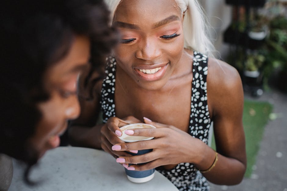 Two women enjoying a coffee and conversation outdoors, capturing a moment of leisure and friendship.