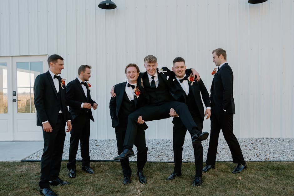 Group of groomsmen having fun at an outdoor wedding. Captured moments of joy and camaraderie.