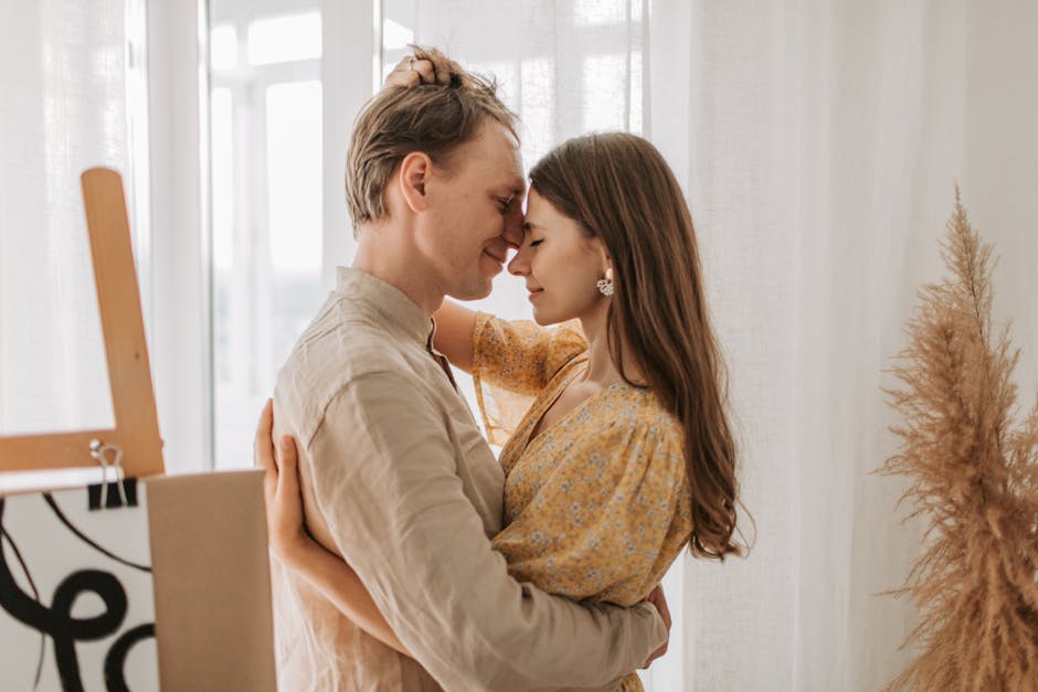 A couple embraces tenderly in a softly lit room, epitomizing love and connection.