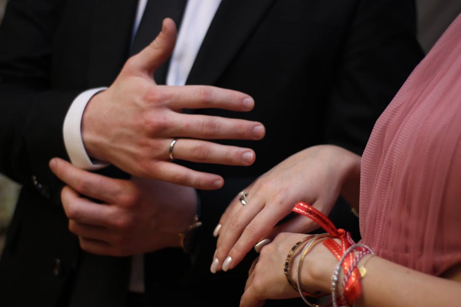 Close-up of newlywed couple showing wedding rings, symbolizing love and commitment.