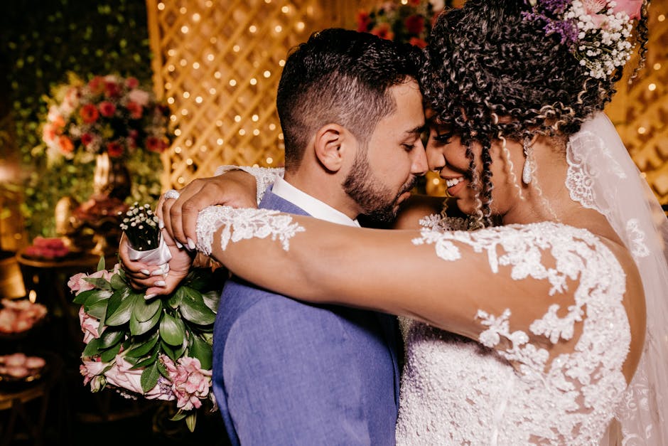 Romantic moment of bride and groom embracing indoors at their wedding ceremony.